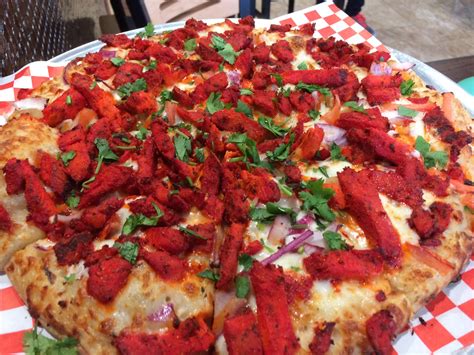 The curry pizza company - Curry sauce, cheese, bell pepper, red onion, diced tomatoes, masala paneer, green onion, cilantro